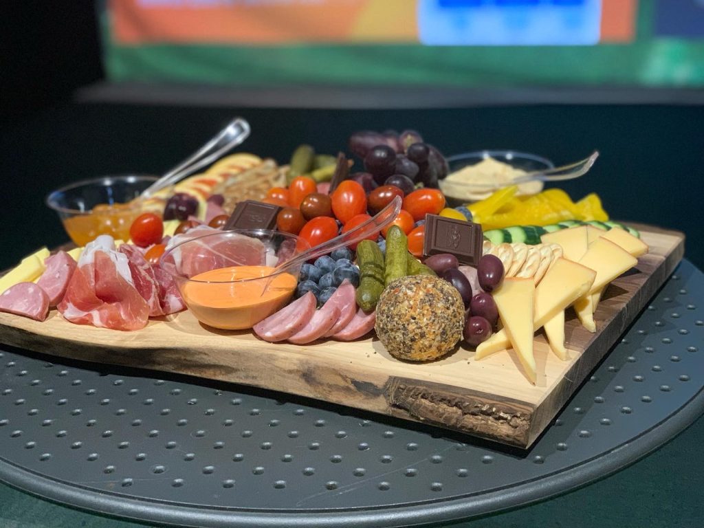 Charcuterie board with meats, cheeses and fruit